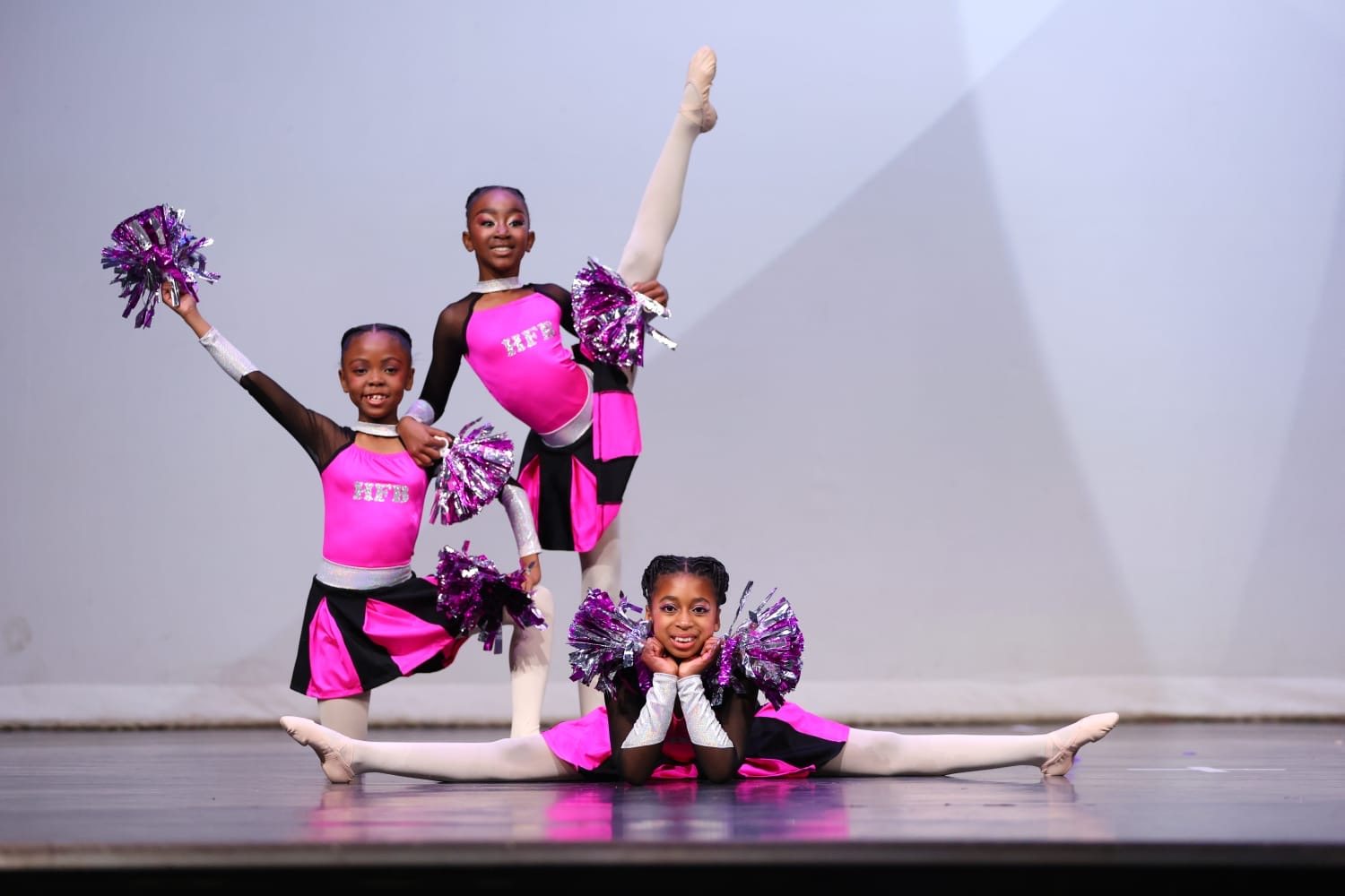 Hip-hop dancers with pompoms performing on stage